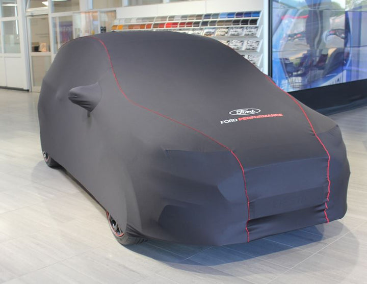 Copertura protettiva Premium nera con rivestimento rosso, logo Ford ovale bianco e logo Ford Performance